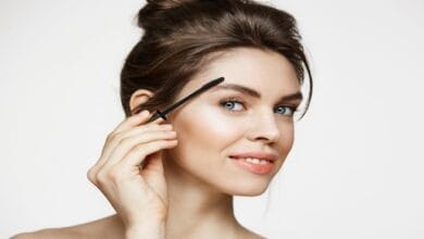 صورة مقربة لحواجب صحية خالية من القشور مع قطرات من الزيوت الطبيعية مثل زيت اللوز وجل الصبار وزيت النيم، ترمز للعلاج الطبيعي والفعّال لقشرة الحواجب.