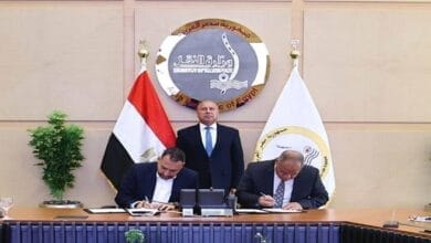 صورة لمعالي المهندس كامل الوزير، وزير النقل، وهو يصافح اللواء مهندس حسن الليثي والأستاذ محمد عزت بعد توقيع بروتوكول شراكة بين سوبر چيت وبوسطة لنقل الشحنات في مصر.